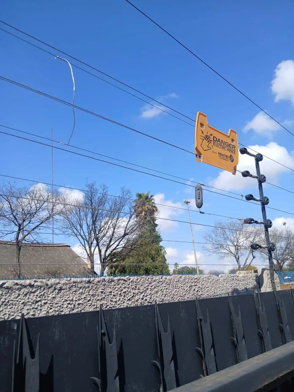 NGL Construction installed Nemtek electric fence with energiser and warning signage on a residential perimeter wall